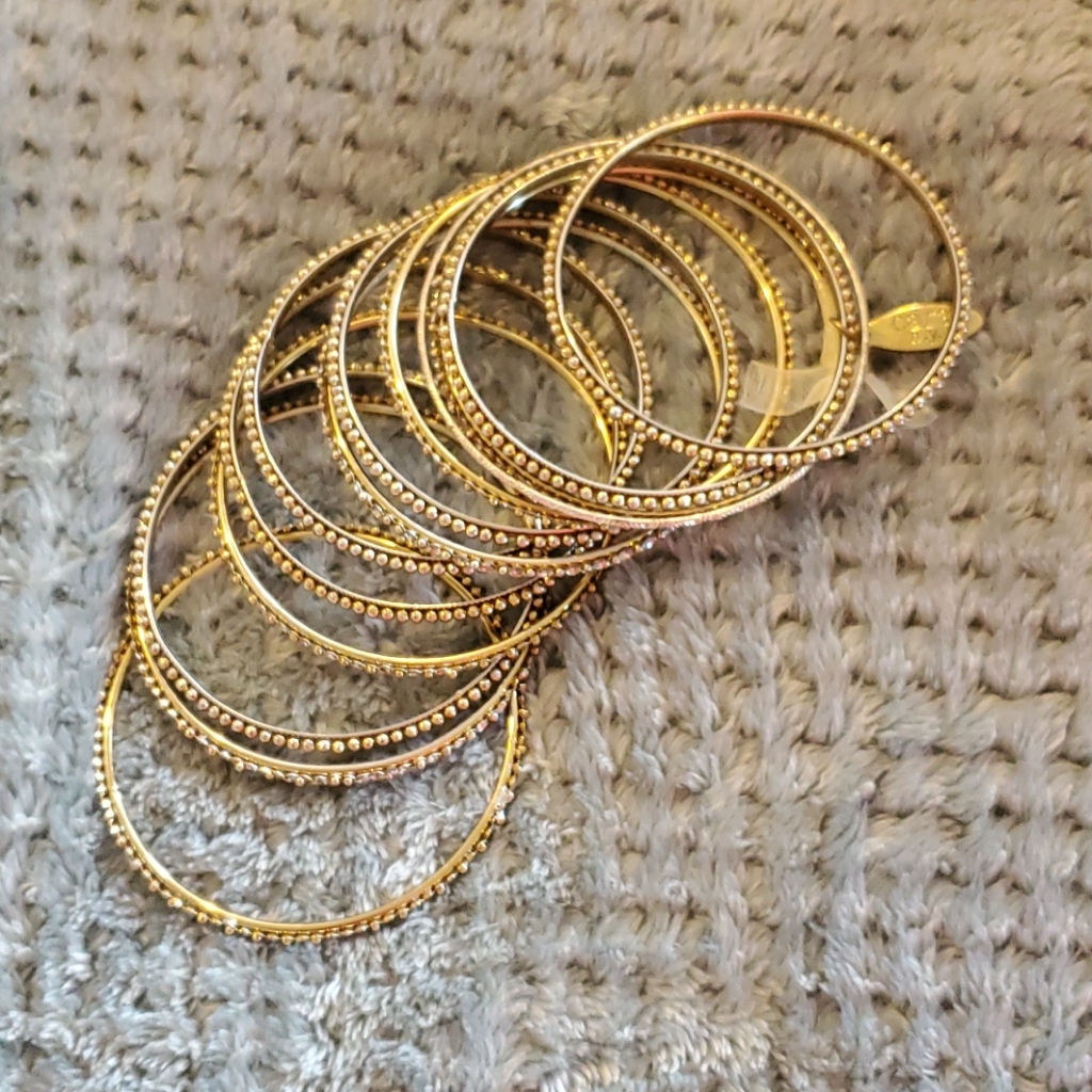 Set Of A Dozen Gold-Toned And Jeweled Bangles